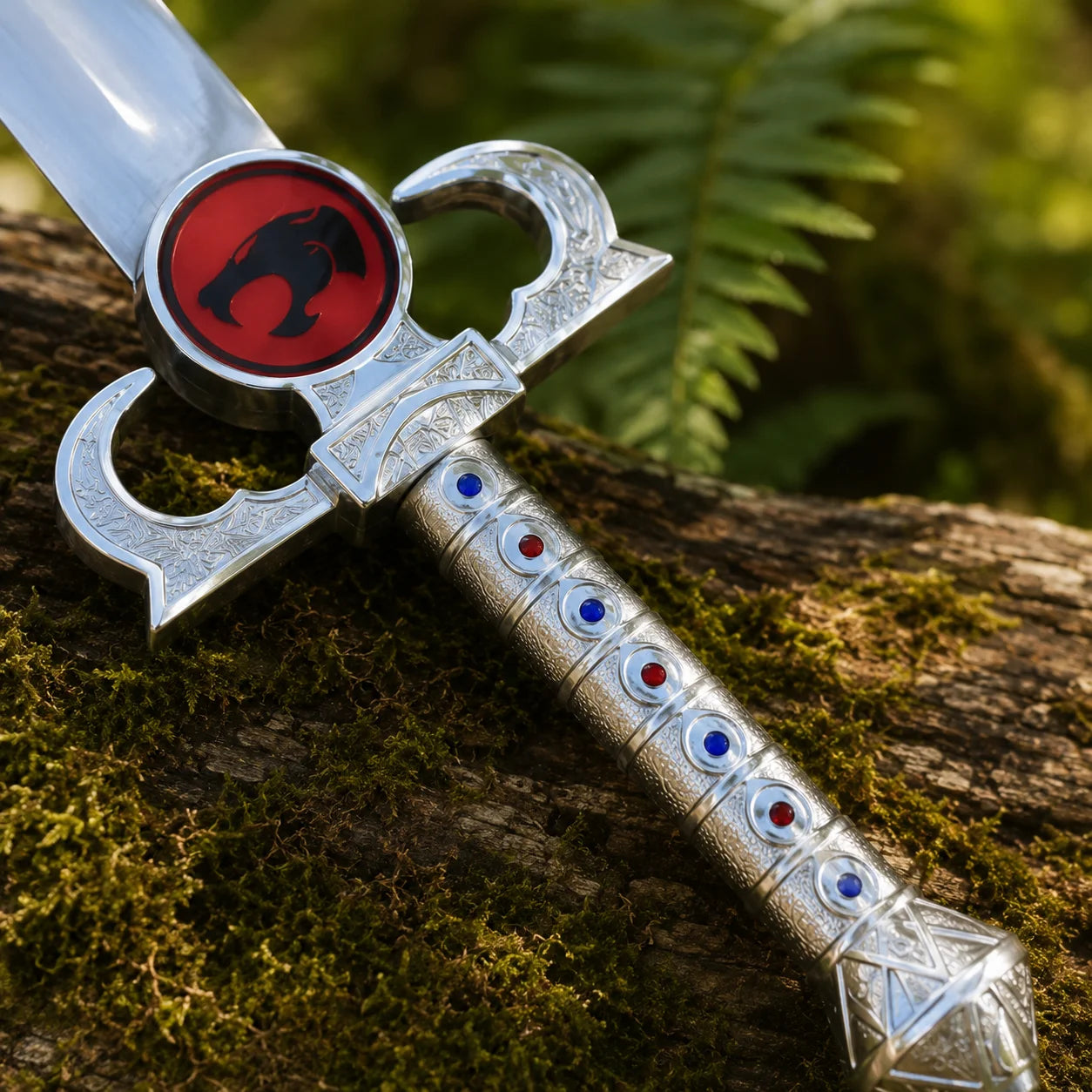 Lion-O Sword of Omens prop replica resting on large mossy rock with ferns – ThunderCats display piece