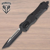 Bushmaster Diamondback OTF Knife collector display piece with black angular handle, silver-tone accent detail, textured grip panels, branded clip, and compact showcase presentation