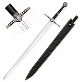 Geralt of Rivia Superior Wolven steel sword prop replica full length on mossy rock with free black leather scabbard showing polished silver blade triple fuller grooves ornate silver angular crossguard black cord grip silver ring spacers and School of the Wolf medallion pommel – Witcher display collectible