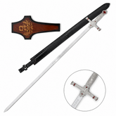 Godric Gryffindor sword prop replica full length diagonal on mossy rock in sunlit fern forest showing polished silver blade with Godric Gryffindor engraving ornate silver hilt and ruby red gemstones – Harry Potter display collectible