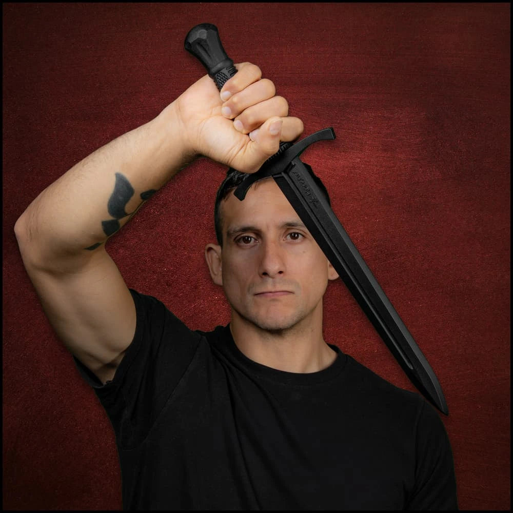 Man posing with Honshu Eastern Martial Arts training dagger overhead – cosplay display collectible