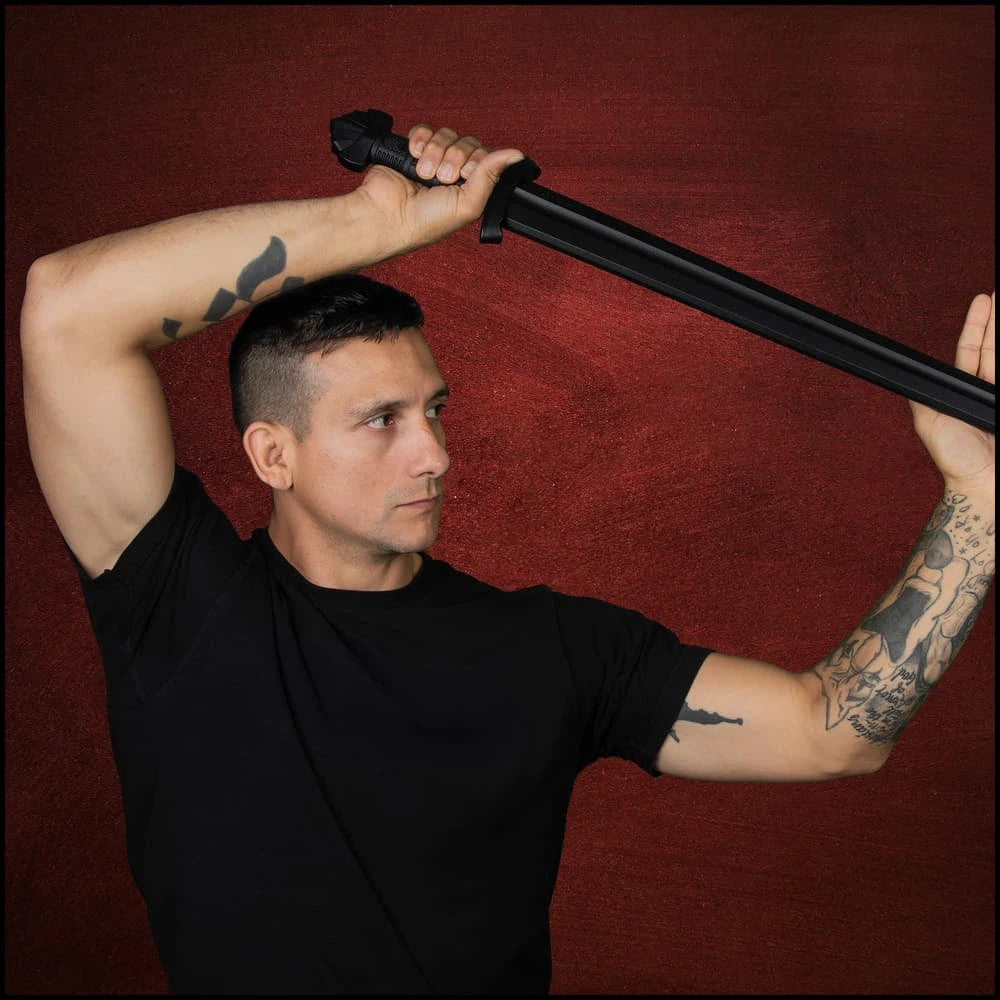 Man posing overhead with Honshu Norse Knight black display sword – cosplay fan collectible