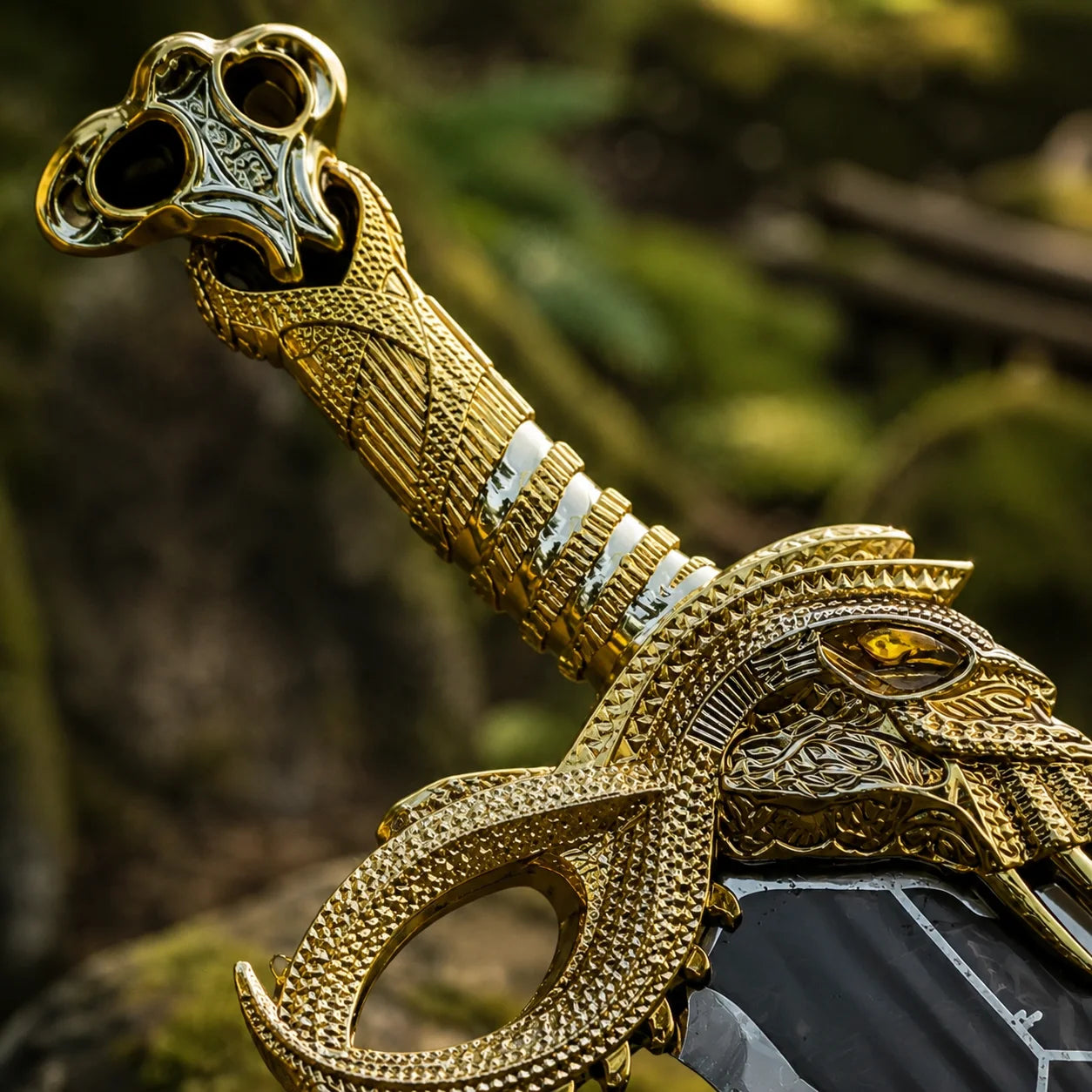 God of War Blades of Chaos fan-inspired prop replica held in gloved hand forest background