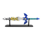 Link Broken Master Sword Zelda Tears of the Kingdom display collectible crafted from premium stainless steel with weathered broken blade detailing, ornate royal-inspired crossguard, emerald decorative accents, decorative display finish, and collector-quality craftsmanship for fantasy gaming collections and cosplay displays.