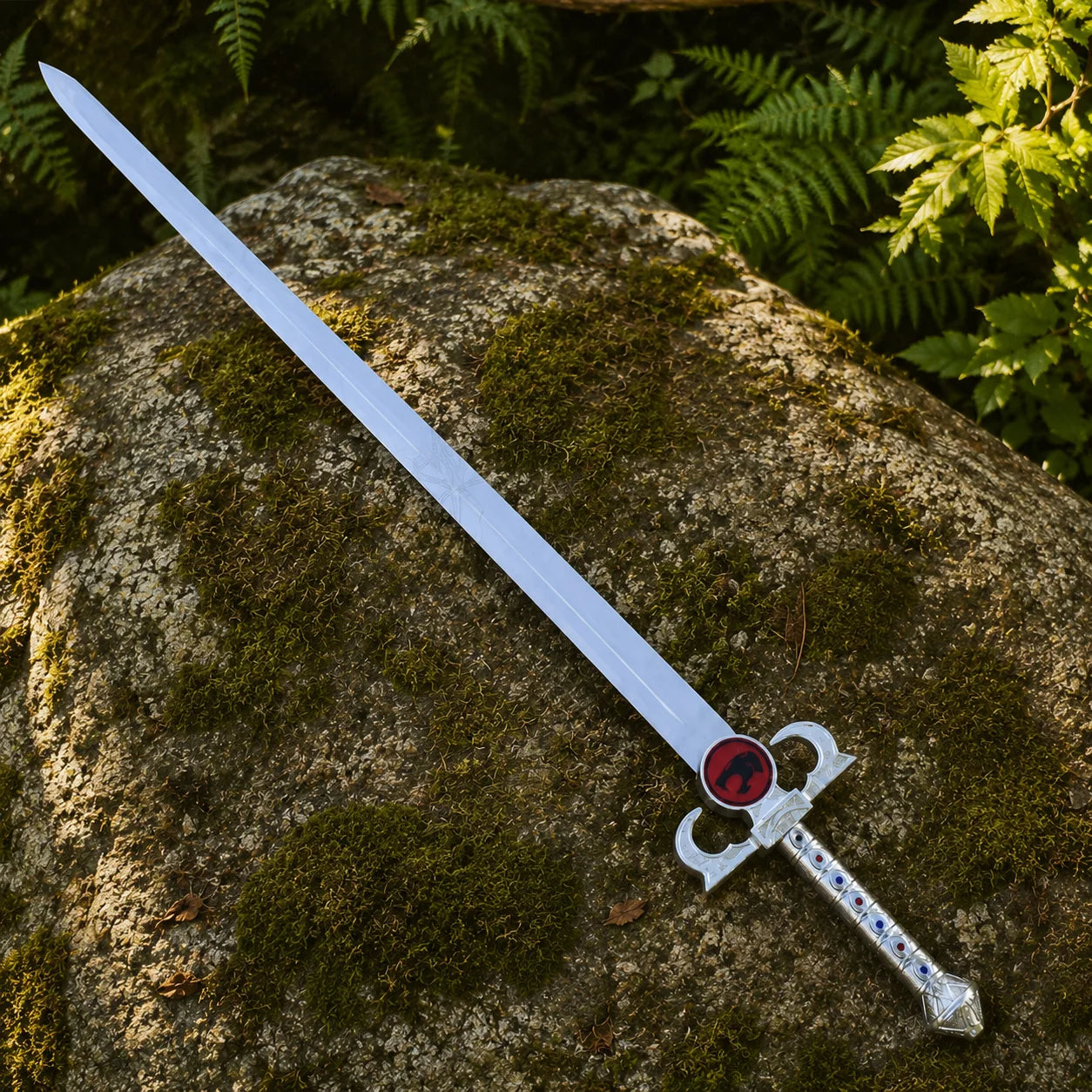 Lion-O Sword of Omens prop replica with black leather scabbard on fallen log in forest – ThunderCats collectible set