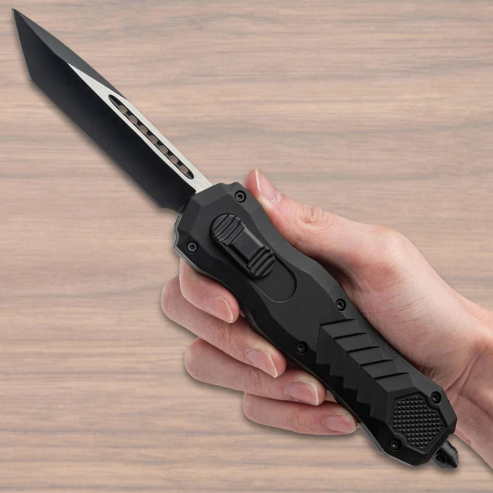 Bushmaster Diamondback OTF Knife collector display piece with black angular handle, silver-tone accent detail, textured grip panels, branded clip, and compact showcase presentation