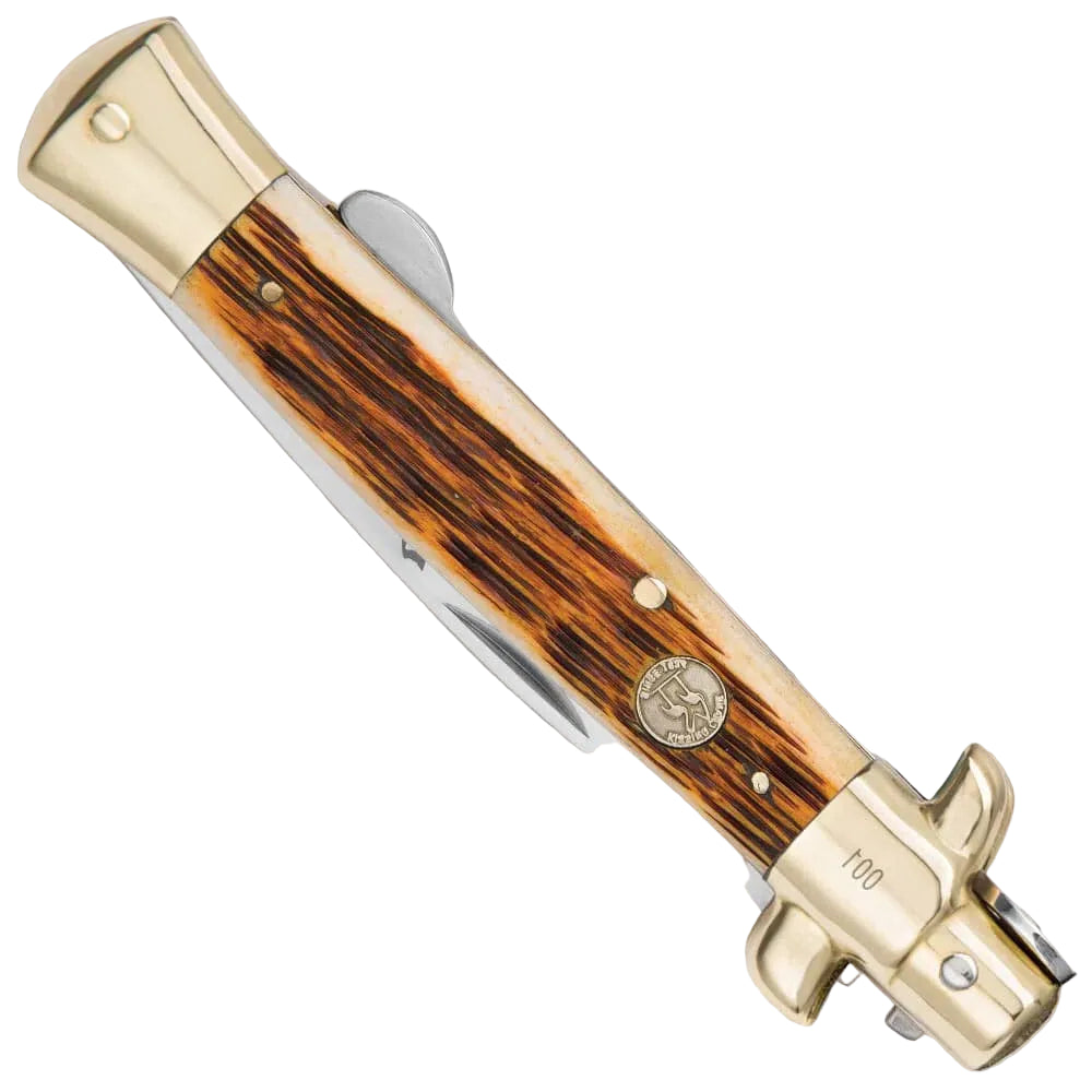 Classic amber bone stiletto pocket knife closed with jigged bone handle and brass bolsters