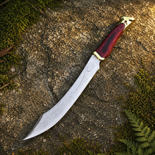 Elven knife of Aragorn prop replica close-up of deep crimson pakkawood grip with rich red-black wood grain texture gold brass crossguard and ornate gold brass pommel cap with cutout notch design and gemstone accent on mossy rock – LOTR Aragorn fan gift