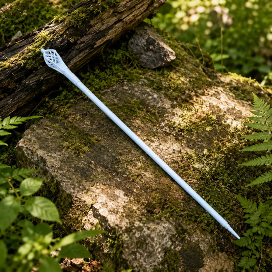 Gandalf the White staff prop replica two-section assembly view on mossy rock showing upper lattice cage topper section and lower smooth cylindrical pale white shaft side by side – LOTR wizard collectible