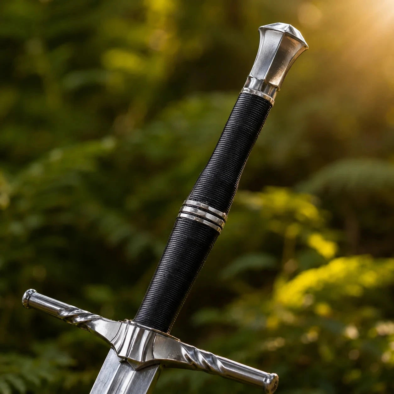 Geralt of Rivia steel sword prop replica close-up macro of polished silver blade tip with triple fuller grooves on mossy rock against sunlit green forest bokeh background – Witcher 3 sword display collectible