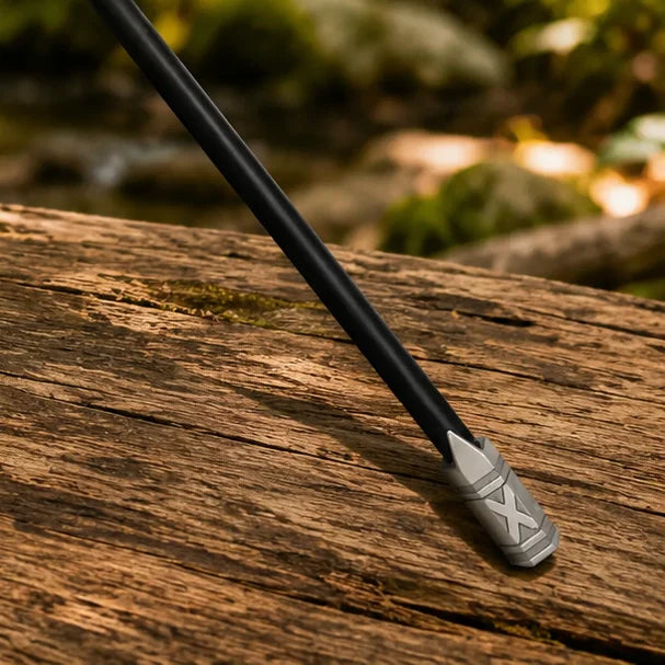 Gimli walking axe prop replica full length side view on mossy forest rock in golden sunlight showing full black shaft crescent axe head and engraved butt cap – LOTR fan gift