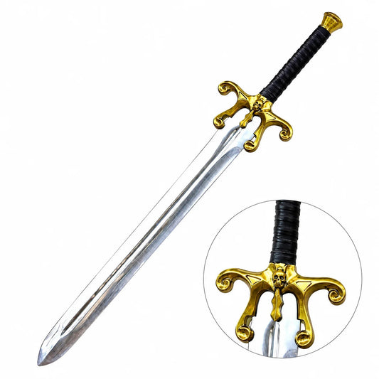He-Man 1987 Movie Sword prop replica hero view on mossy rock in sunlit green forest showing silver chrome mirror-polish display finish blade single central fuller groove ornate gold brass skull cross-guard scrollwork curls black leather-wrapped handle and gold brass pommel cap – Masters of the Universe display collectible