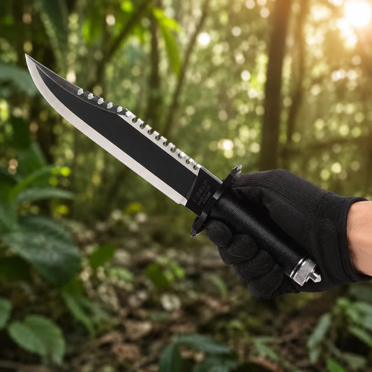 Rambo First Blood Part II knife prop replica wide display view on mossy rock showing full black matte blade with serrated saw-tooth spine polished silver bevel black crossguard black cord-wrapped handle with diamond crosshatch texture and knurled silver pommel cap – John Rambo First Blood Part II fan gift