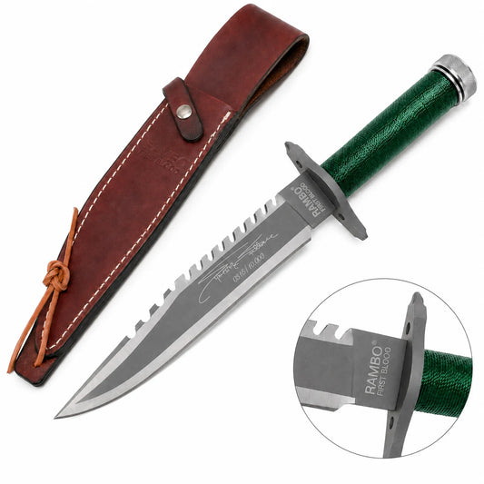 Rambo First Blood Stallone Signature Edition knife prop replica full hero view on mossy rock with brown leather RAMBO FIRST BLOOD embossed sheath snap button closure and leather tie lace showing grey silver two-tone satin display finish blade serrated saw-tooth spine Stallone signature engraving and limited edition numbering – movie display collectible