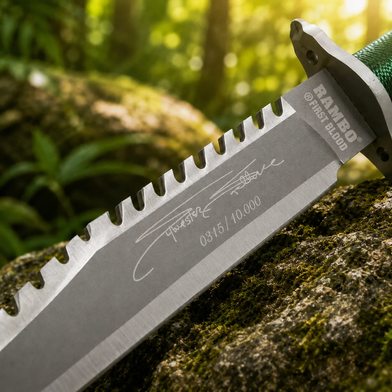 Rambo First Blood Stallone Signature Edition knife prop replica dramatic hero display on mossy log showing full grey silver two-tone satin display finish blade with serrated saw-tooth spine Stallone signature engraving limited edition numbering RAMBO FIRST BLOOD crossguard engraving and green paracord-wrapped hollow handle – Rambo fan gift wall display
