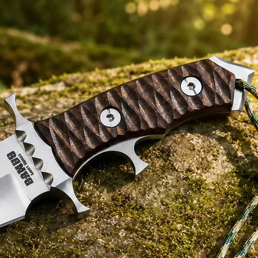 Rambo V Last Blood Heartstopper knife prop replica close-up macro of silver satin display finish double-edged dagger blade with dual hollow grind central ridge and RAMBO LAST BLOOD engraving near ricasso on mossy rock in sunlit green forest – John Rambo Last Blood 2019 movie prop replica collectible
