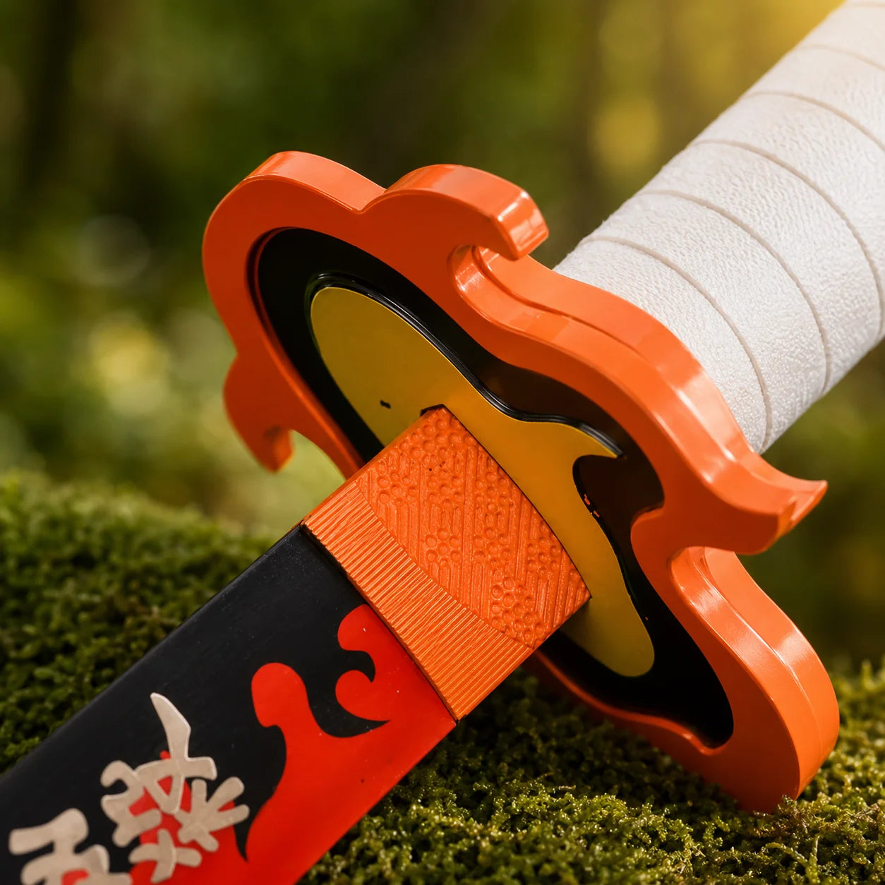 Rengoku Nichirin sword prop replica displayed on moss-covered rock in forest – Demon Slayer collectible