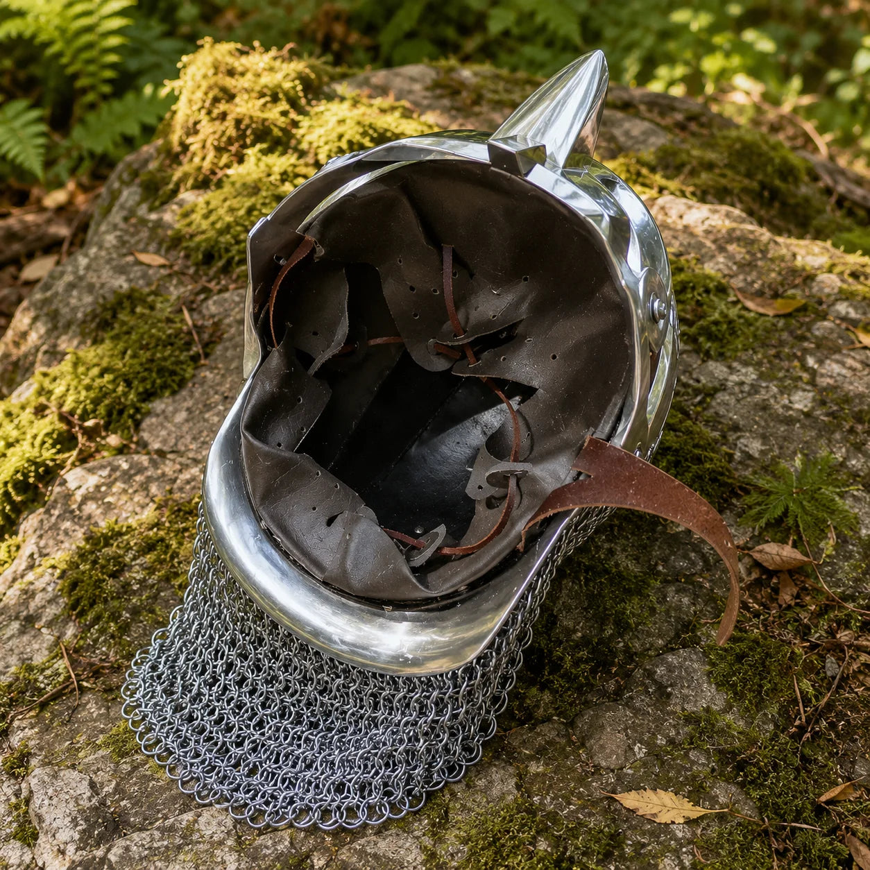 Roman Gladiator Maximus helmet replica three-quarter left angle view with chainmail aventail on mossy log in forest