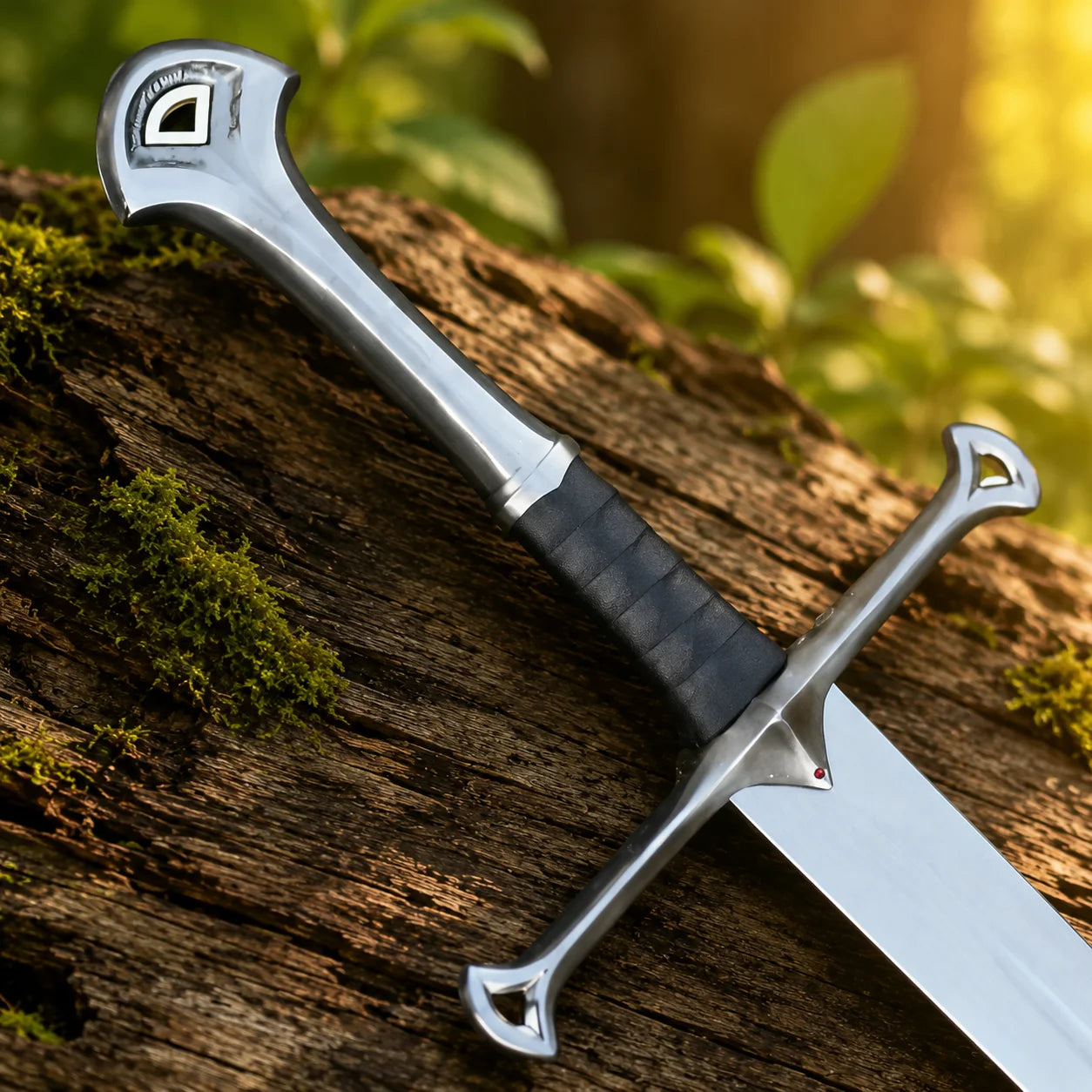 Close-up of Narsil prop replica crescent pommel with Gondor emblem and black wrapped grip on mossy log in golden bokeh – LOTR Isildur collectible